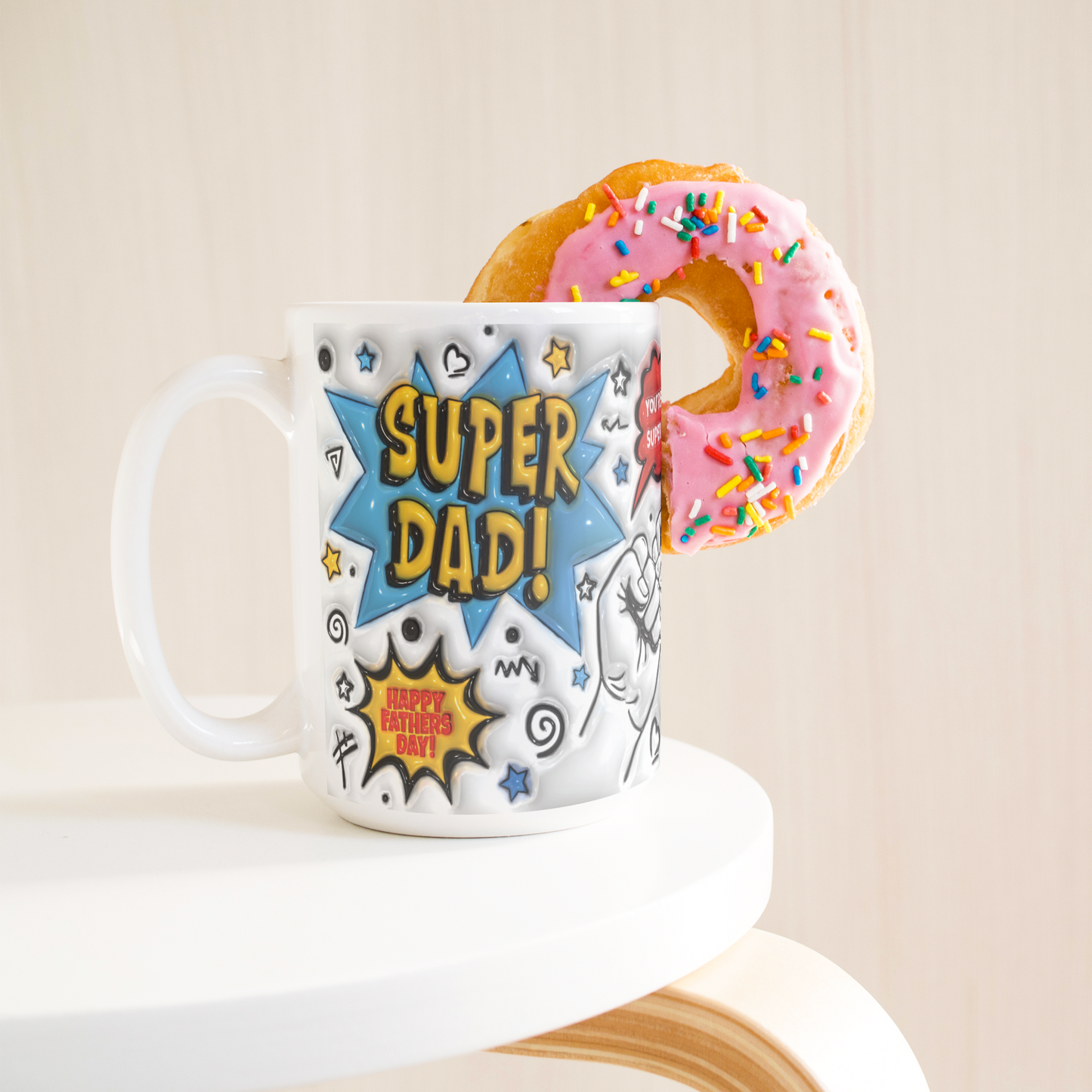 Fathers_Day_SUPER_DAD_Mug_Simulated_3D__15ozWhiteMugLifetsyleDonutLH_Mockup.png