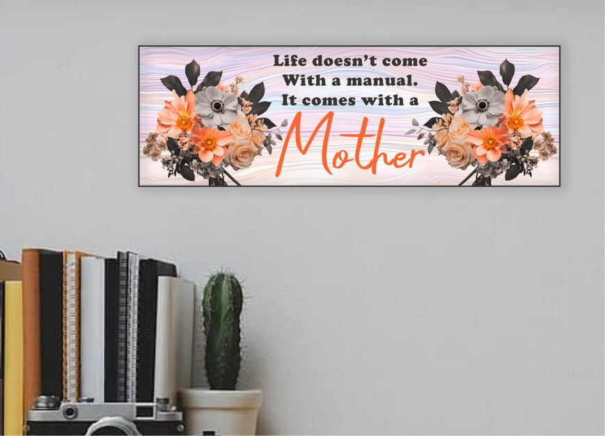 A rectangular sign with a wood background featuring floral patterns and the text 'Life doesn't come With a manual. It comes with a Mother'.